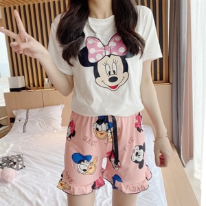 Roze en witte Minnie, Mickey en Donald bedrukte zomerpyjama, gedragen door een vrouw in een huis