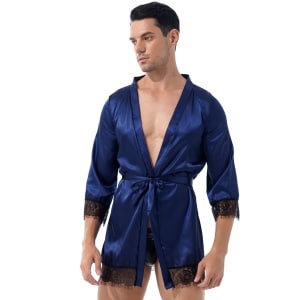 bruine man die een marineblauwe korte satijnen kimono-pyjama met zwarte kanten rand en V-hals draagt